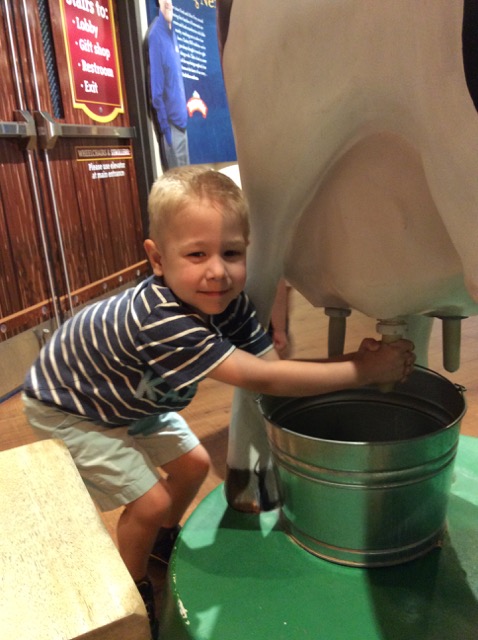 Photo of Hiatt milking a fake cow